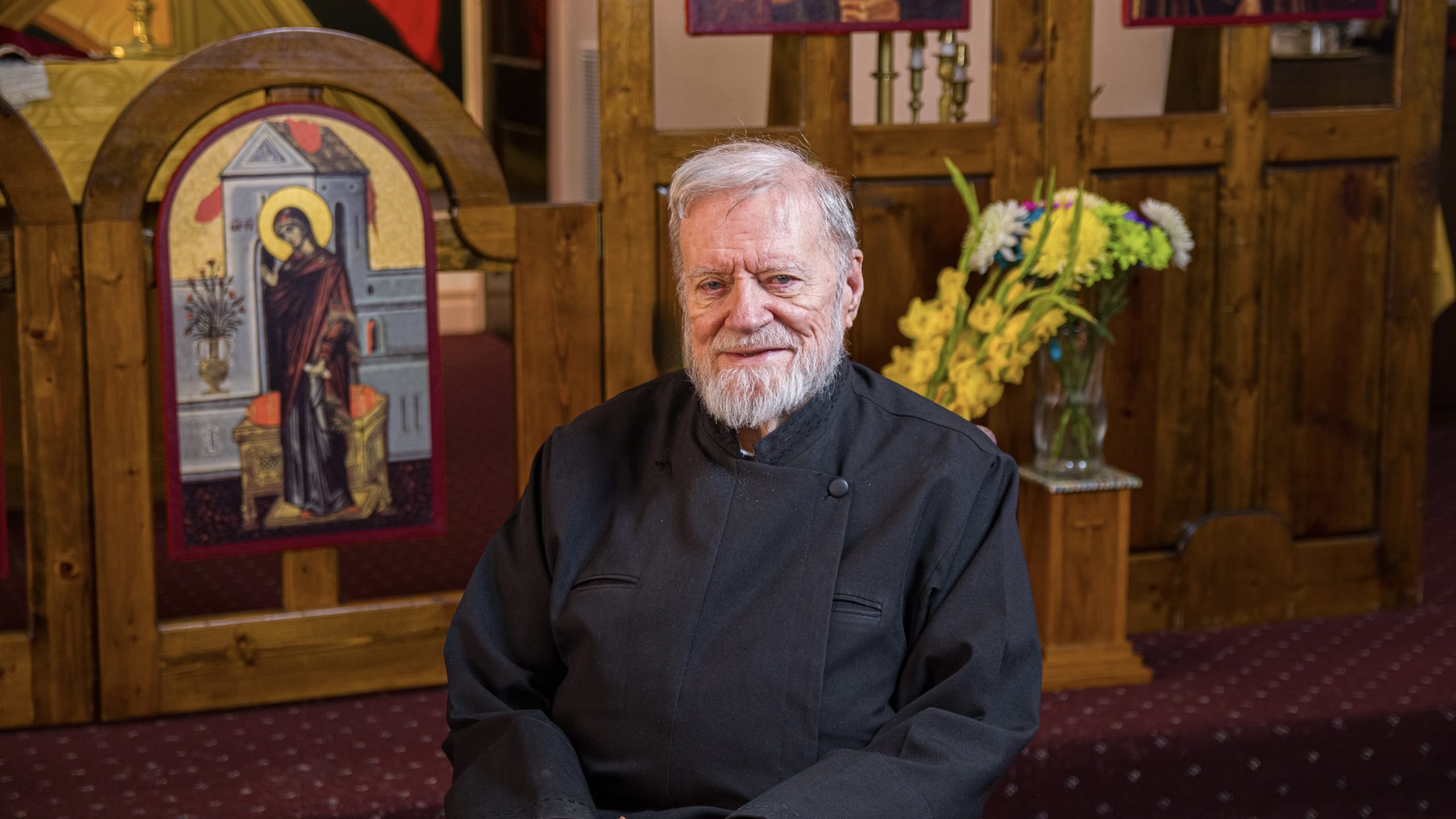 Pastor Reardon sits in front of a religious icon